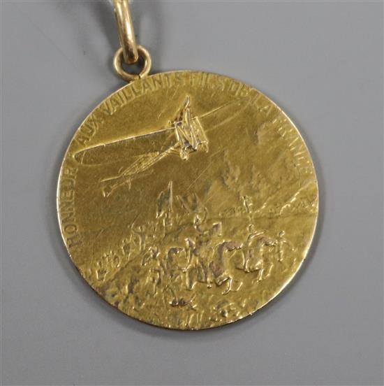 A 14k gold aviation medal inscribed Honneur Aux Vaillants Fils De La France.